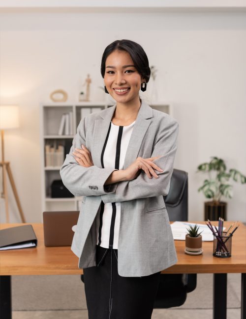 Portrait of young beautiful business asian woman in the office. Crossed arms
